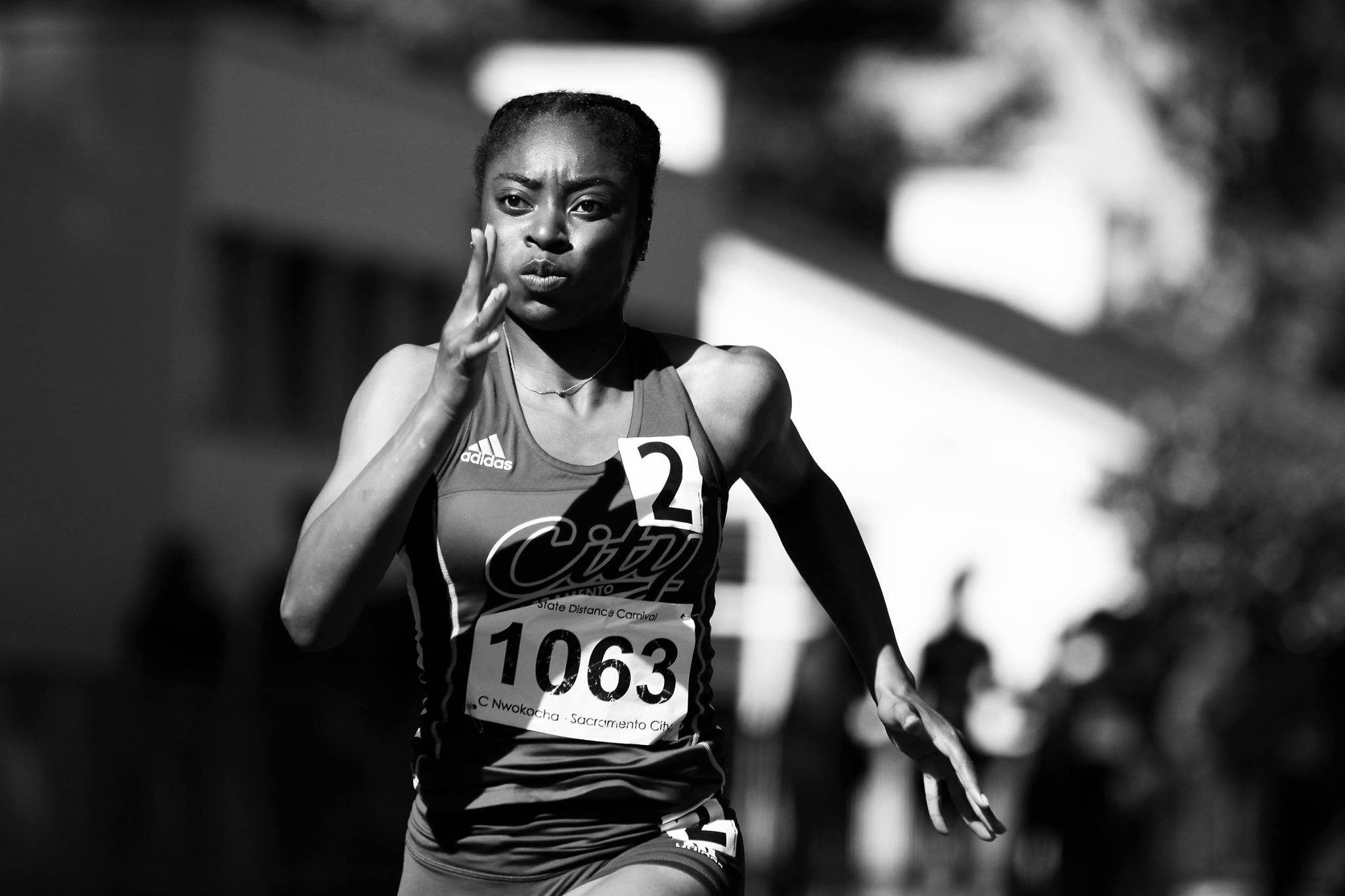 Sprinter at full speed during a Reno-Tahoe track meet, black and white