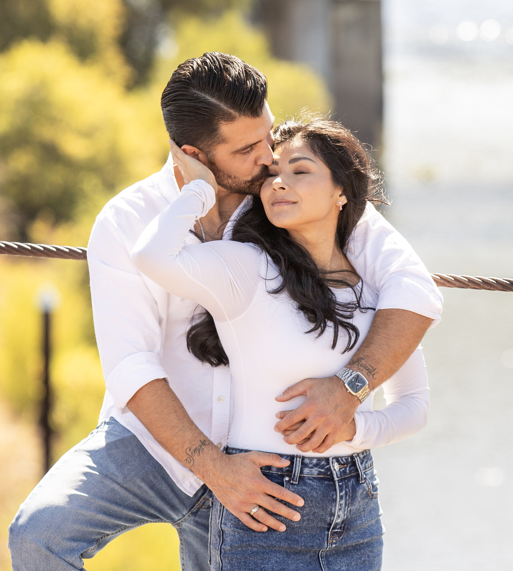 A tender forehead kiss in golden afternoon light