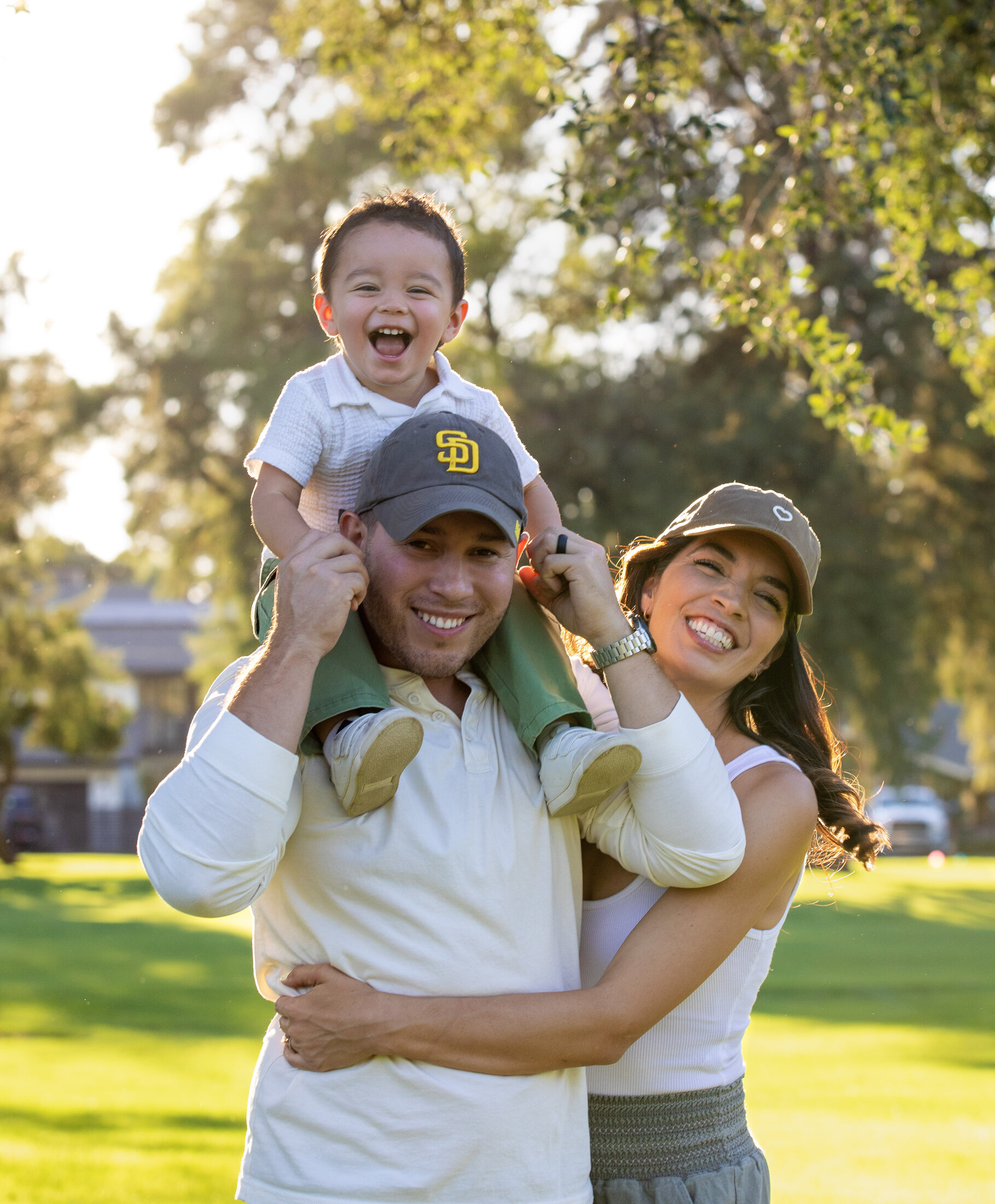 Parents laughing with their son on dad's shoulders